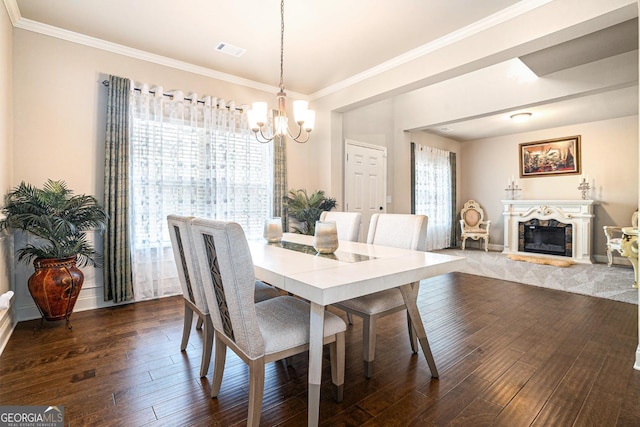 dining room featuring dark wood-style floors, a wealth of natural light, visible vents, and a fireplace with raised hearth