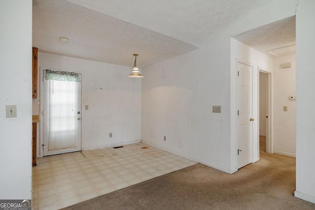 interior space with baseboards, visible vents, a textured ceiling, and tile patterned floors