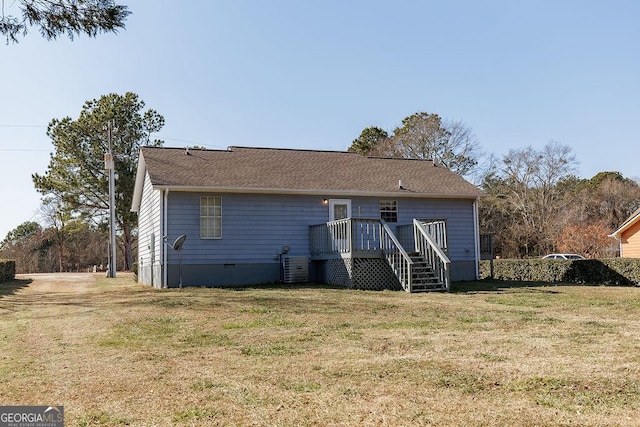 back of property with stairs, crawl space, a wooden deck, and a lawn