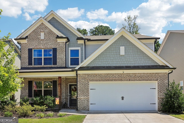 craftsman inspired home featuring a garage, brick siding, and driveway