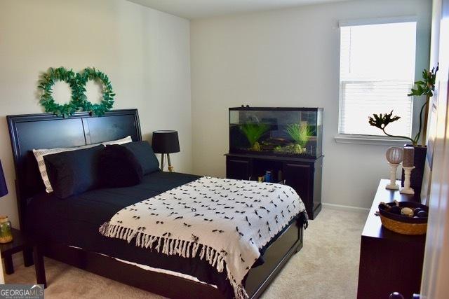 carpeted bedroom featuring baseboards