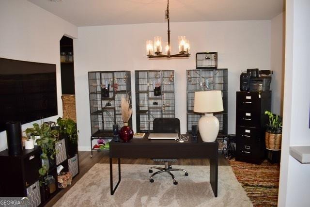 office space featuring a chandelier and wood finished floors