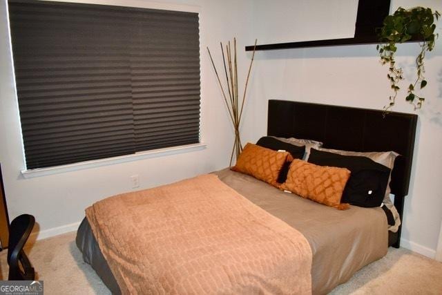 bedroom with carpet flooring and baseboards