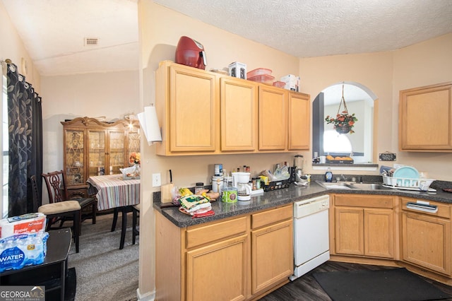 kitchen with visible vents, dark countertops, white dishwasher, a textured ceiling, and dark carpet