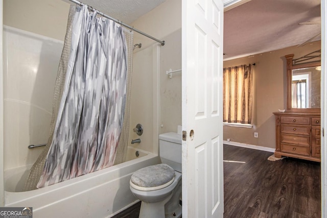 full bathroom with shower / tub combo, baseboards, toilet, wood finished floors, and a textured ceiling