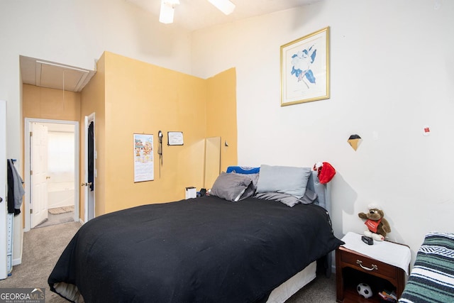 bedroom featuring carpet floors, attic access, ceiling fan, and ensuite bathroom