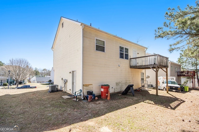 rear view of property featuring central air condition unit