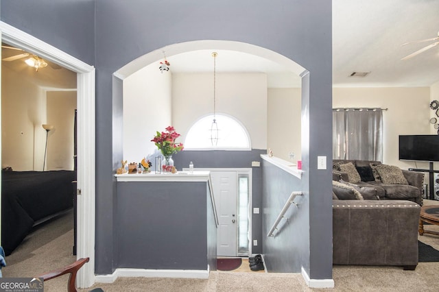 carpeted foyer entrance with visible vents