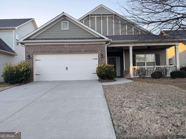 view of front facade featuring a garage, concrete driveway, brick siding, and a porch