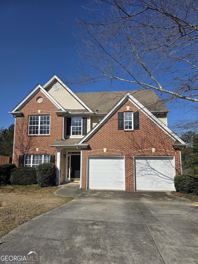 traditional home featuring concrete driveway, brick siding, and an attached garage