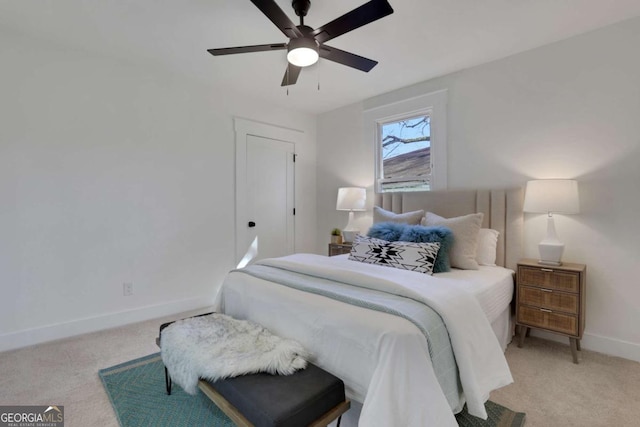 bedroom featuring light carpet, ceiling fan, and baseboards