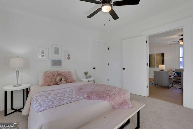 bedroom featuring light colored carpet and ceiling fan