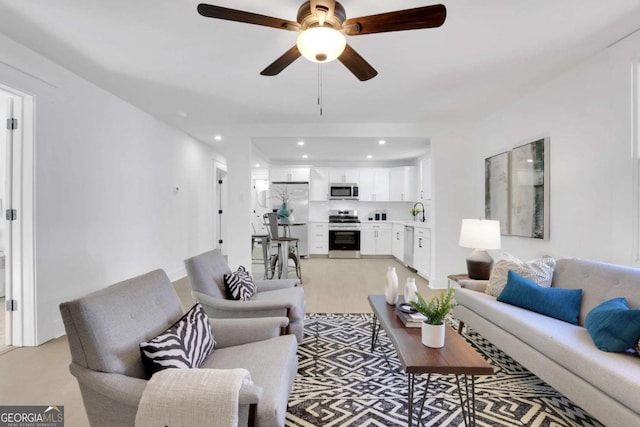 living room featuring ceiling fan and recessed lighting