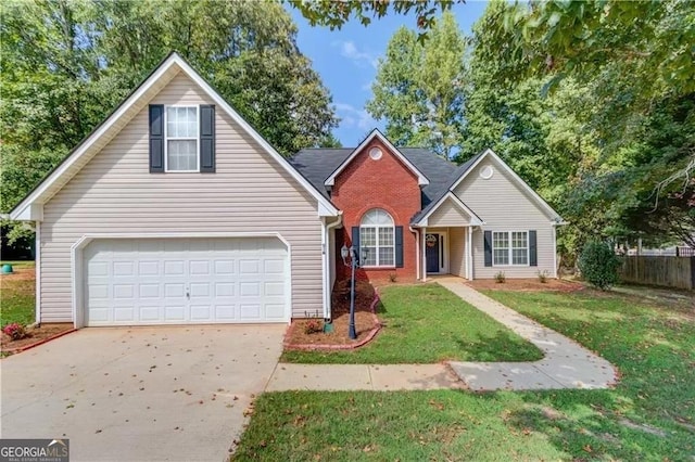 traditional-style house featuring a garage, brick siding, fence, driveway, and a front lawn