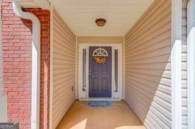 property entrance featuring brick siding