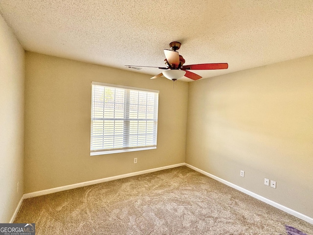 unfurnished room with a textured ceiling, ceiling fan, carpet, and baseboards