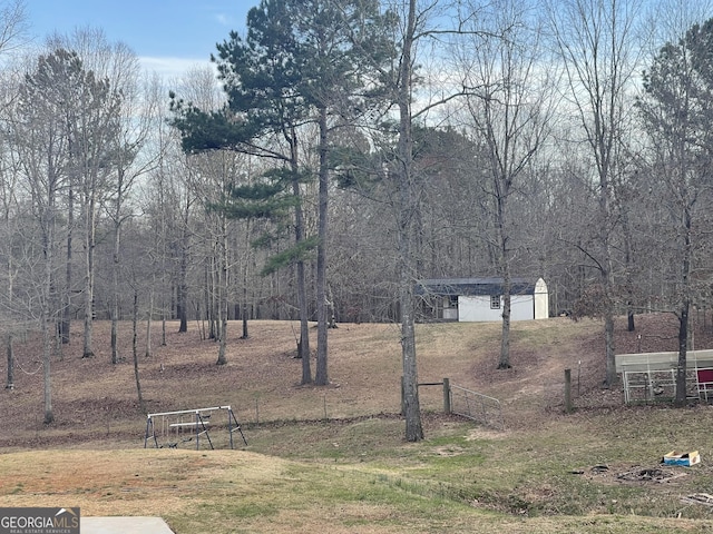 view of yard with an outbuilding and fence