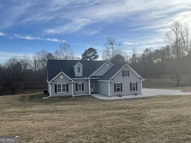 traditional-style home featuring a front lawn