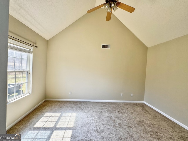 unfurnished room featuring baseboards, visible vents, a ceiling fan, vaulted ceiling, and carpet floors