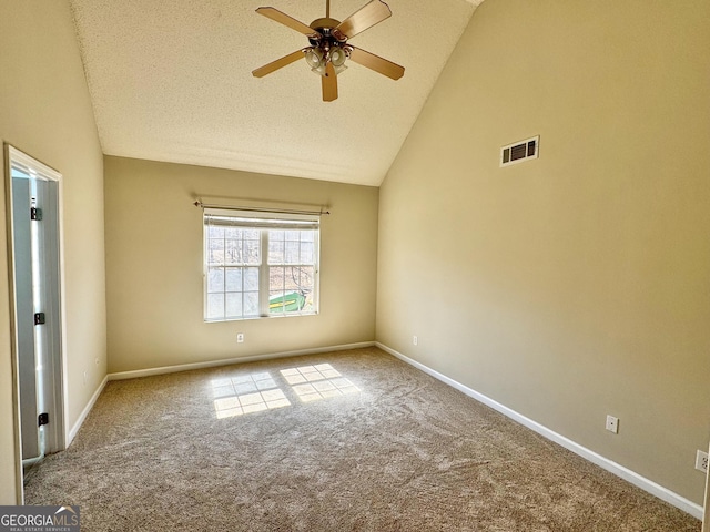 carpeted spare room with baseboards, visible vents, ceiling fan, a textured ceiling, and high vaulted ceiling