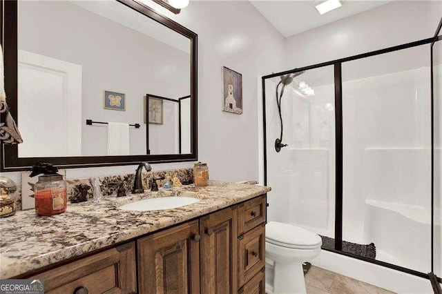 full bathroom featuring toilet, a stall shower, tile patterned floors, and vanity