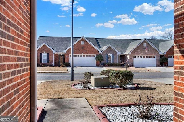 view of front facade with concrete driveway and brick siding