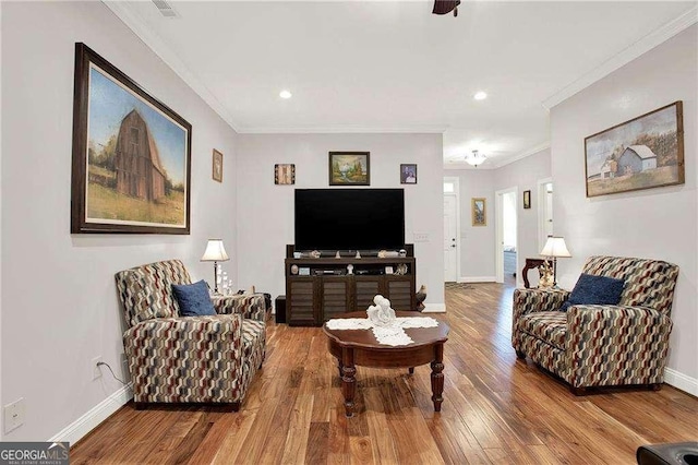 living area with baseboards, ornamental molding, wood finished floors, and recessed lighting