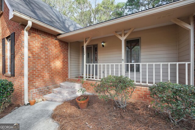 rear view of property with cooling unit, a sunroom, brick siding, and a yard