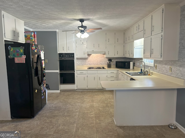 kitchen featuring decorative backsplash, a sink, a peninsula, under cabinet range hood, and black appliances