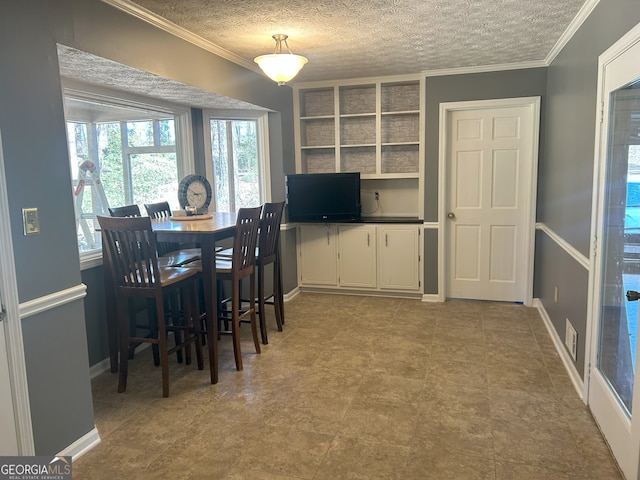 dining space with visible vents, crown molding, a textured ceiling, and baseboards