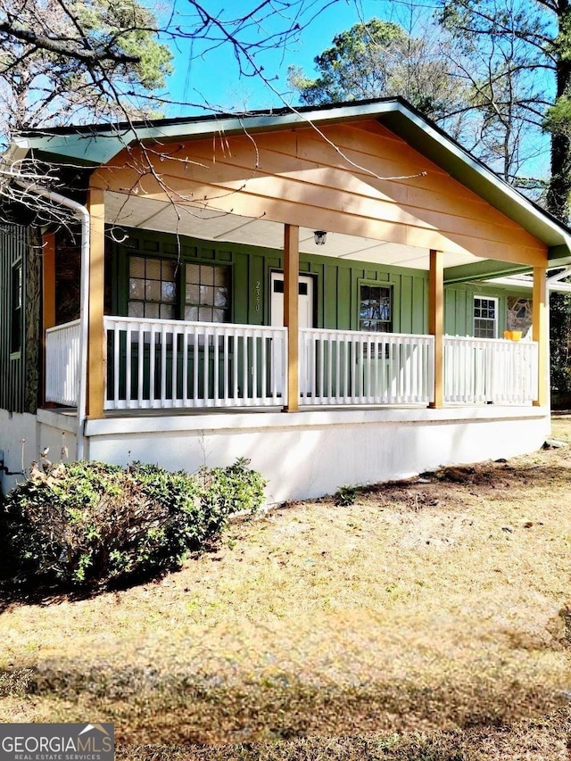 view of side of home featuring a porch and board and batten siding