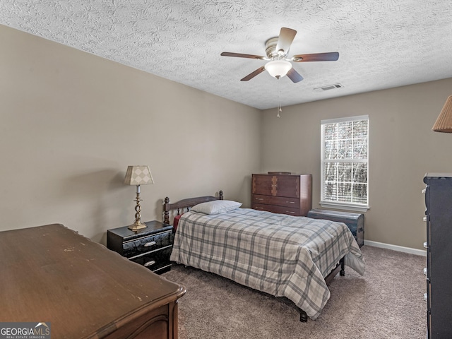 bedroom featuring carpet, visible vents, ceiling fan, a textured ceiling, and baseboards