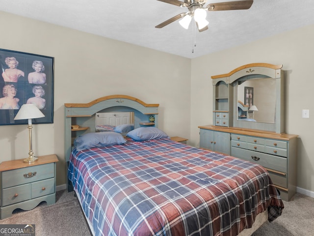 bedroom with carpet floors, a textured ceiling, baseboards, and a ceiling fan