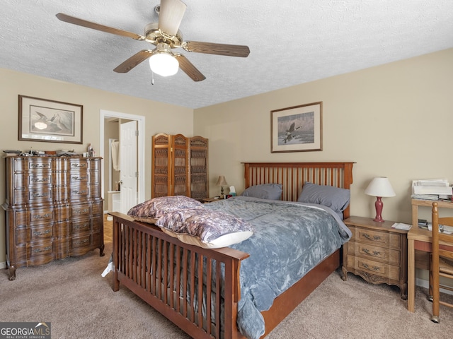 carpeted bedroom featuring a textured ceiling and ceiling fan