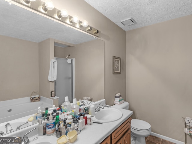 full bathroom with a textured ceiling, a garden tub, toilet, vanity, and a shower stall