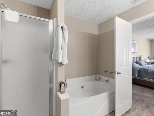 full bathroom featuring connected bathroom, tile patterned flooring, a textured ceiling, a shower stall, and a bath