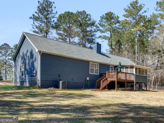 back of house with fence, a sunroom, stairs, a yard, and a chimney