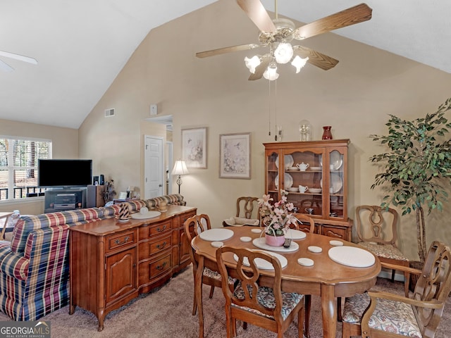 dining space featuring high vaulted ceiling, light colored carpet, visible vents, and ceiling fan