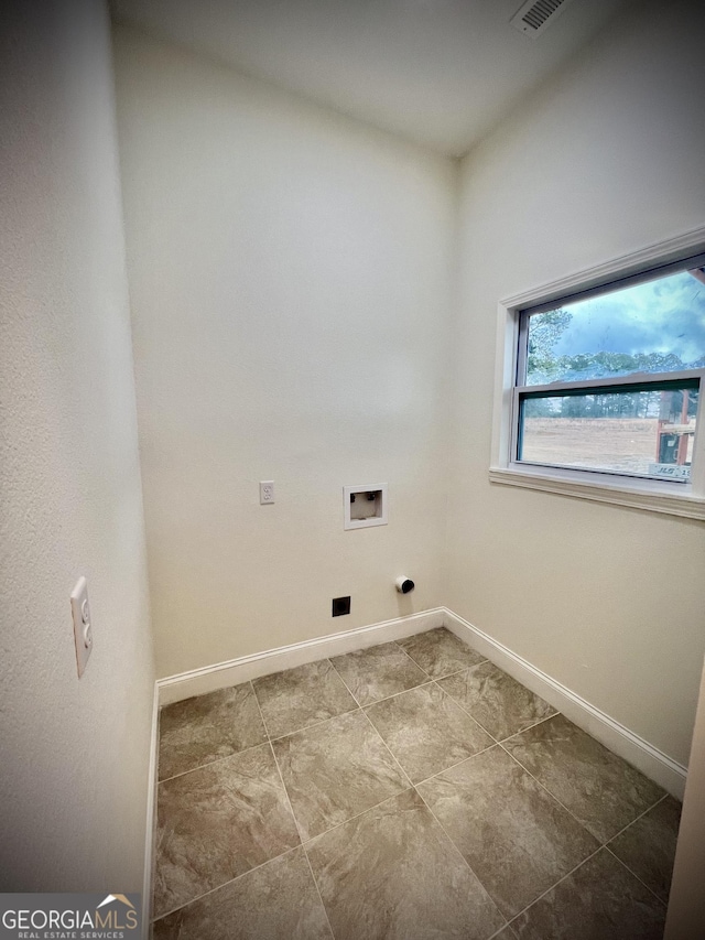 laundry area with hookup for a washing machine, laundry area, visible vents, and baseboards