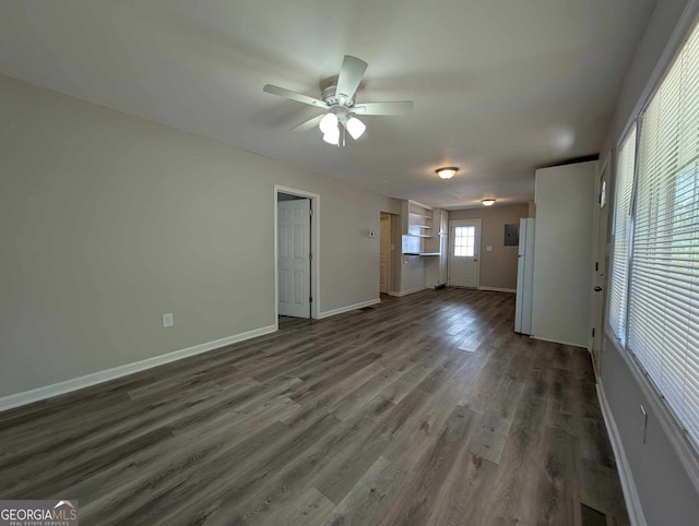 unfurnished living room featuring a ceiling fan, visible vents, baseboards, and wood finished floors