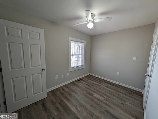 unfurnished bedroom with ceiling fan, baseboards, and wood finished floors