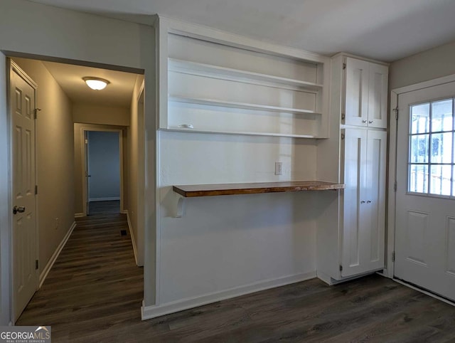 interior space featuring dark wood-style floors and baseboards