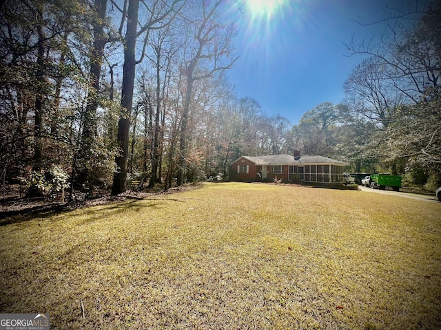 view of yard featuring a sunroom