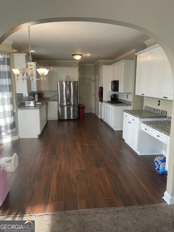 kitchen with white cabinetry, dark wood finished floors, freestanding refrigerator, and crown molding