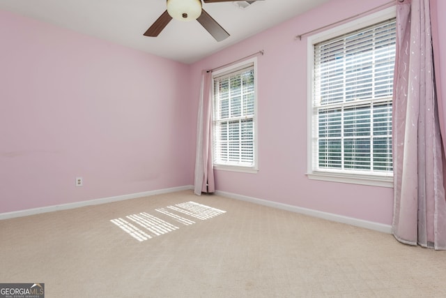 unfurnished room with carpet, a ceiling fan, and baseboards