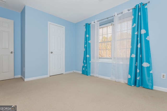 interior space with carpet and baseboards