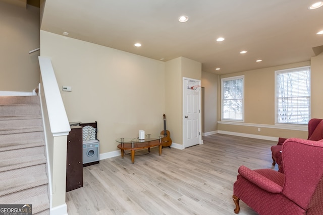 sitting room featuring recessed lighting, stairway, baseboards, and wood finished floors