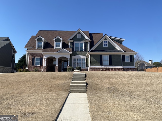 view of front of house with brick siding and fence