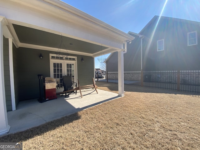 view of patio / terrace featuring fence and french doors