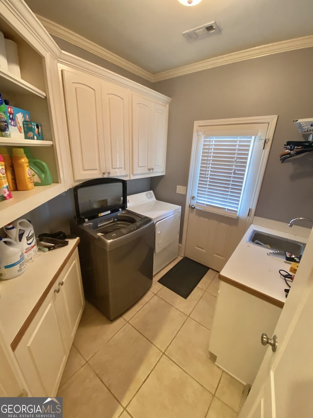 laundry area with separate washer and dryer, a sink, visible vents, cabinet space, and crown molding